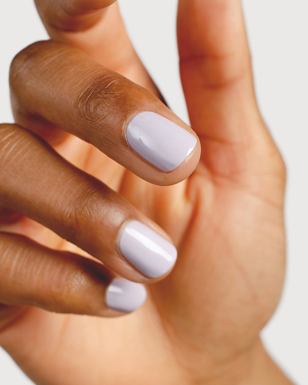 Thistle purple-grey nail polish hand swatch on medium skin tone close-up