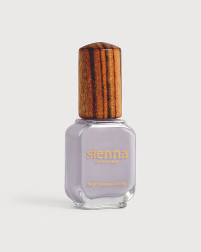 Pastel purple-grey nail polish bottle with timber cap