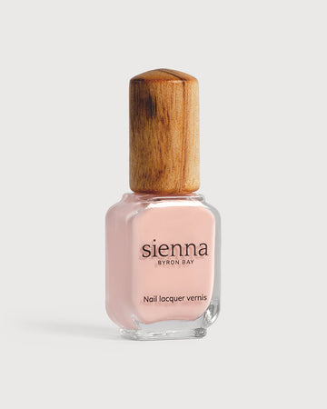 pastel pink nail polish bottle with timber cap