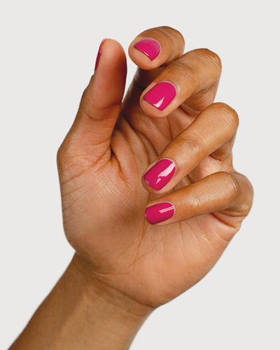 fuschia pink nail polish hand swatch on medium skin tone 