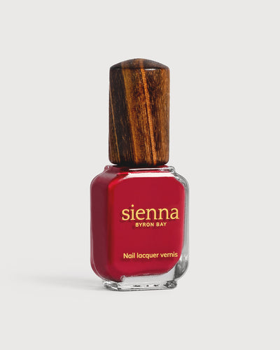 classic red nail polish bottle with timber cap