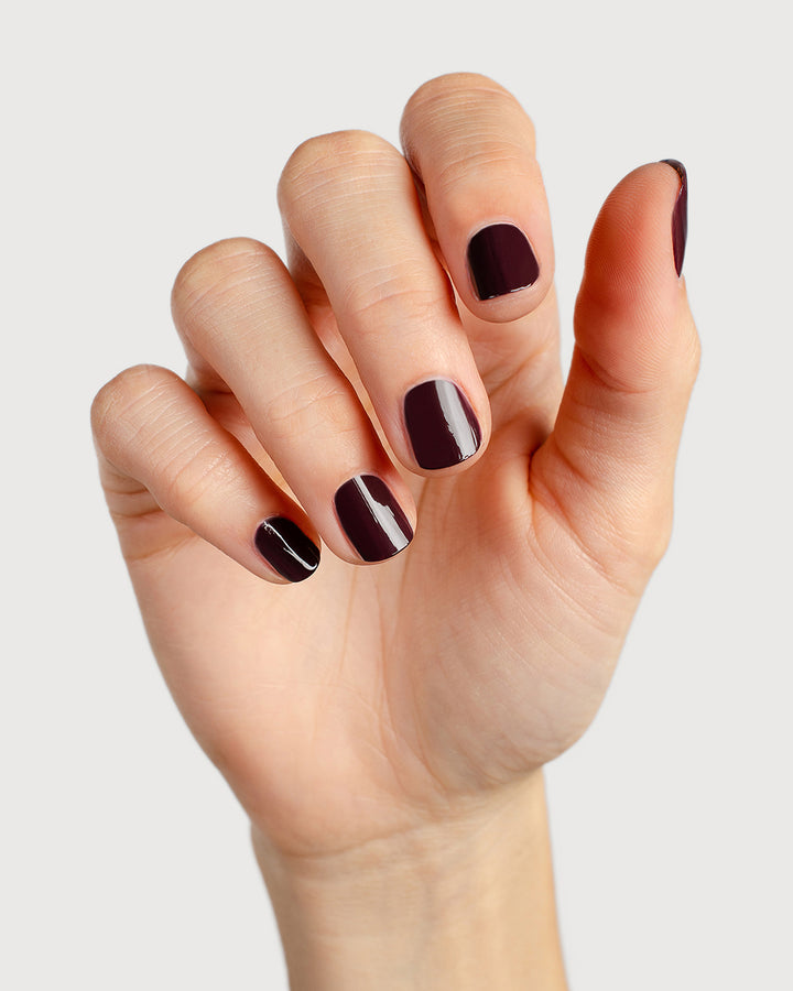 Aubergine nail polish hand swatch on fair skin tone