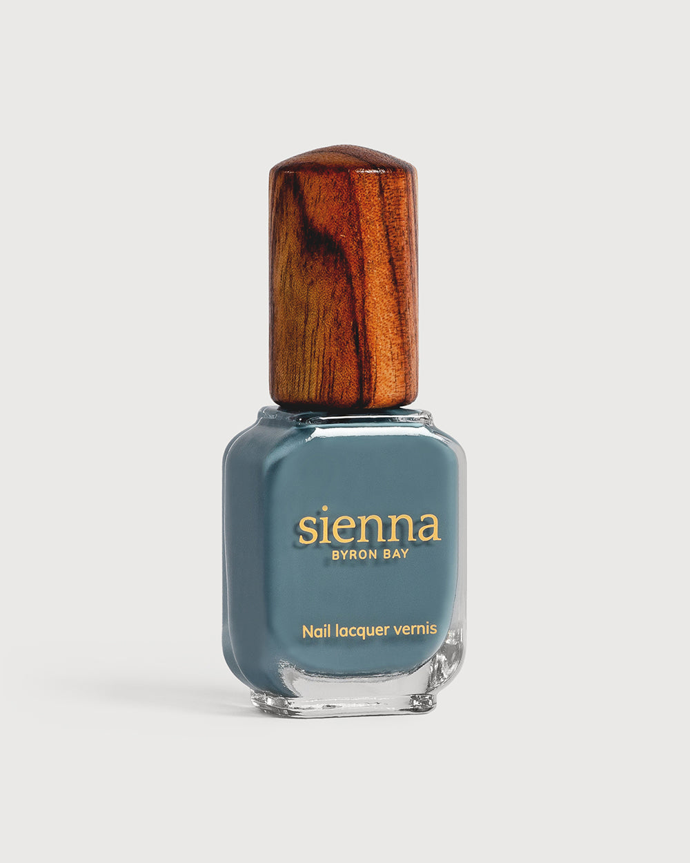Mid grey-blue nail polish glass bottle with timber cap