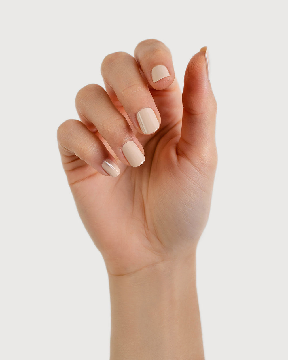 classic beige nail polish hand swatch on fair skin tone