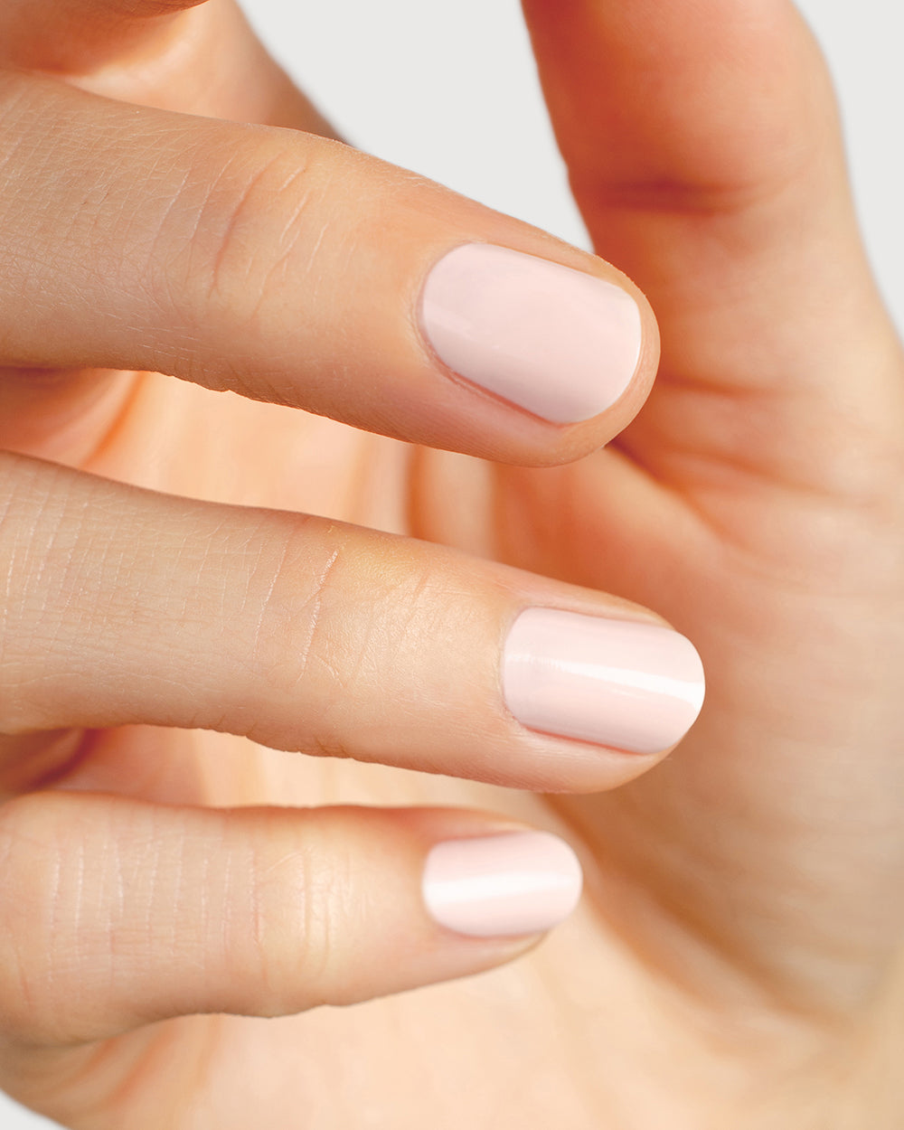 rosewater pink nail polish hand swatch on fair skin tone up close