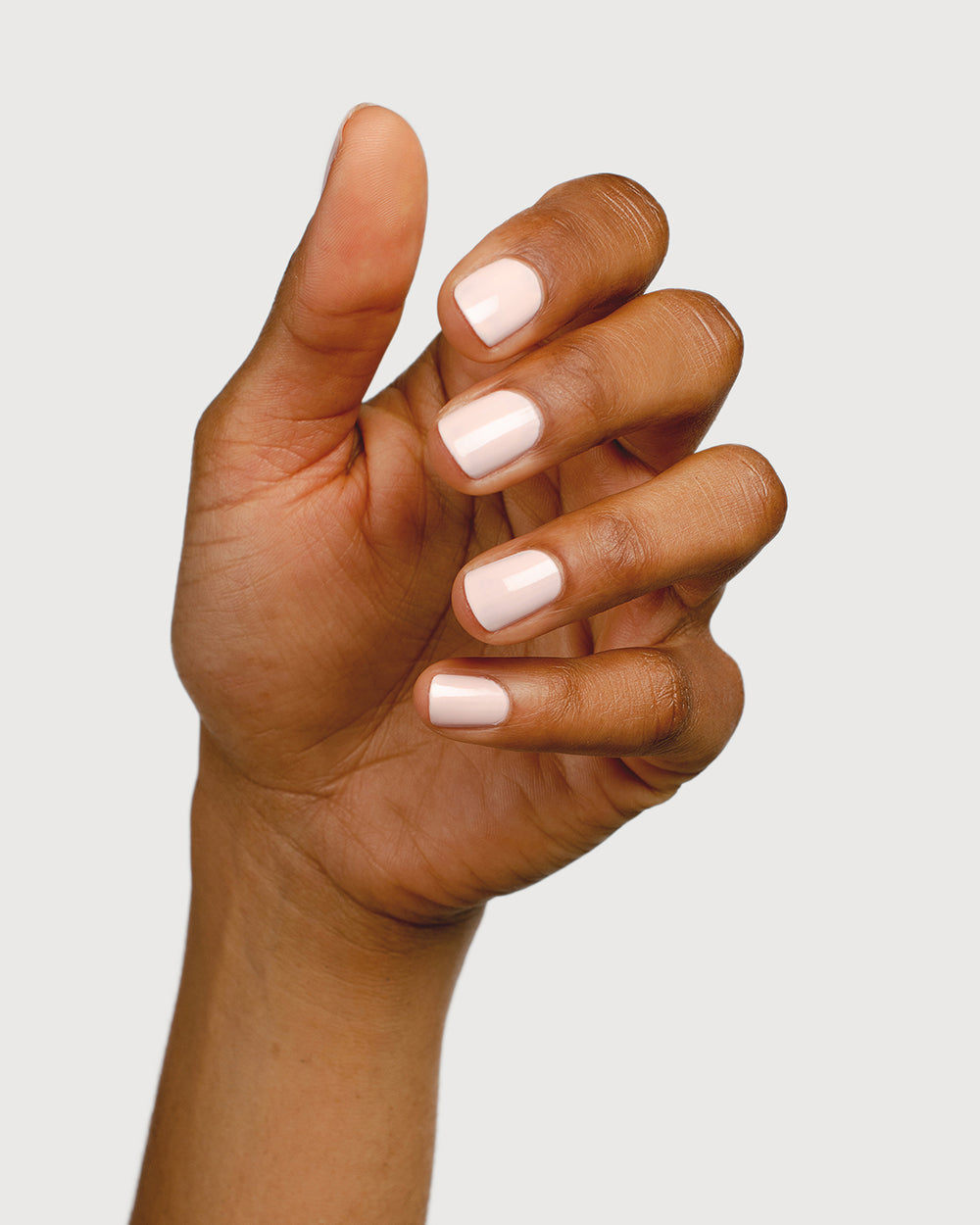 rosewater pink nail polish hand swatch on medium skin tone