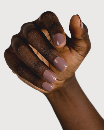 dusty mauve nail polish hand swatch on dark skin tone