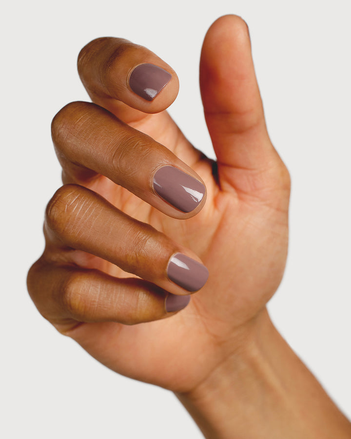 dusty mauve nail polish hand swatch on medium skin tone