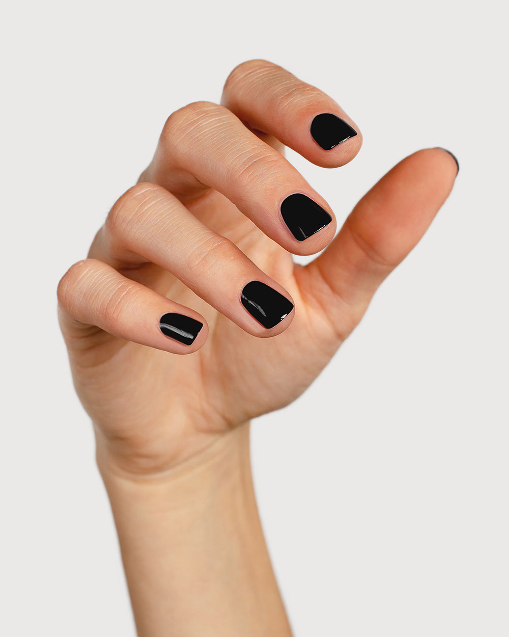 jet black nail polish hand swatch on fair skin tone