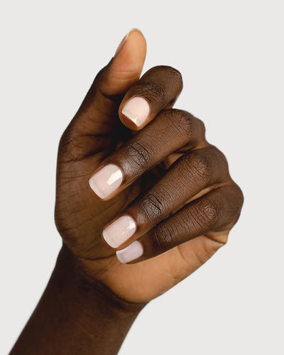 light rosewater pink sheer nail polish hand swatch on dark skin tone