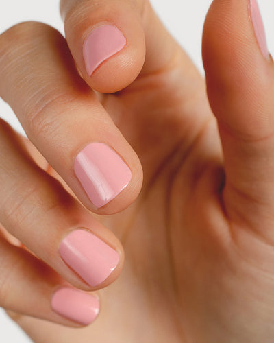 Cherry blossom pink nail polish hand swatch on fair skin tone up-close