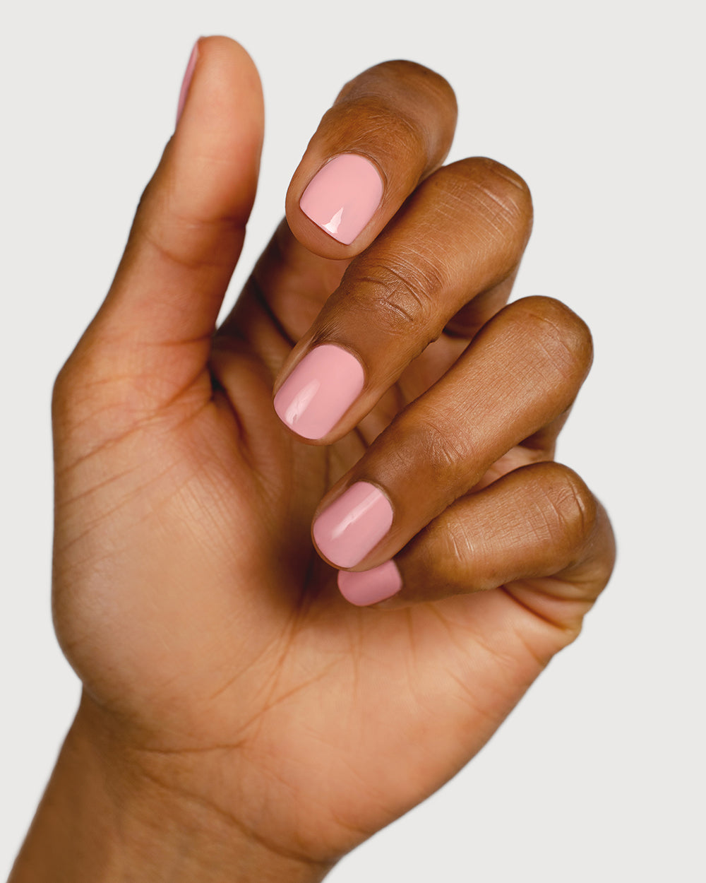 Cherry blossom pink nail polish hand swatch on medium skin tone