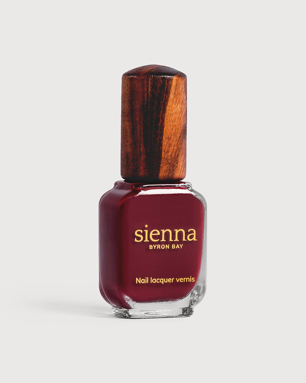 Plum red nail polish glass bottle with timber cap