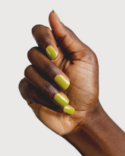 Avocado green nail polish hand swatch on dark skin tone