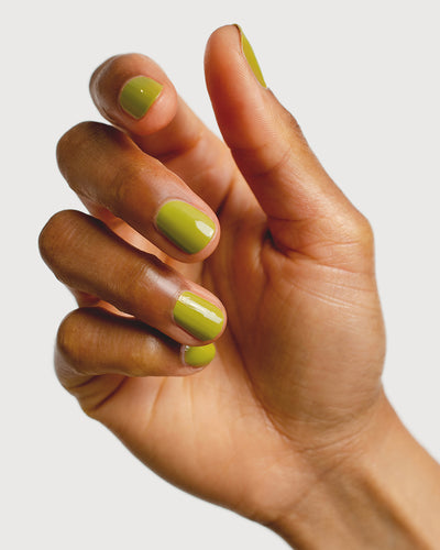 green nail polish hand swatch on medium skin tone