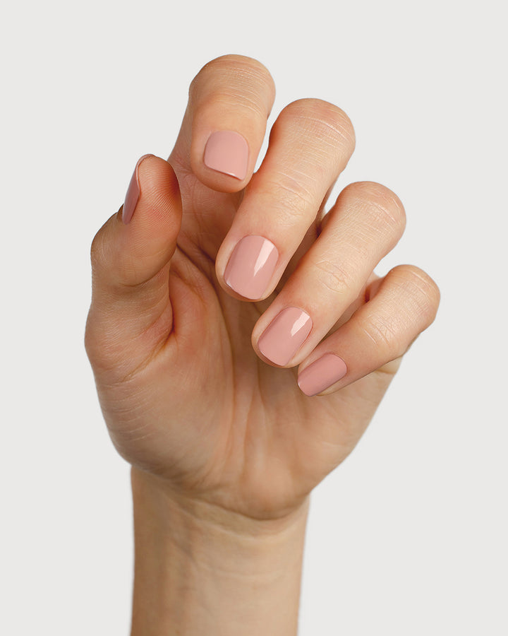 Dusty rose nail polish hand swatch on fair skin tone