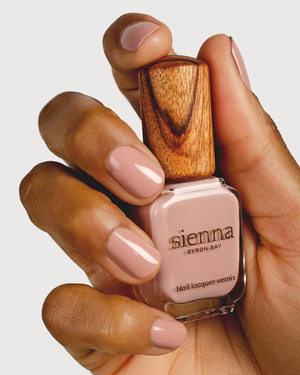 Womans hand on hip wearing Rosie creme non-toxic nail polish by Sienna Byron Bay, wearing cream thick dress
