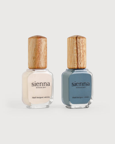 Eggshell white and mid grey-blue nail polish bottles with timber cap