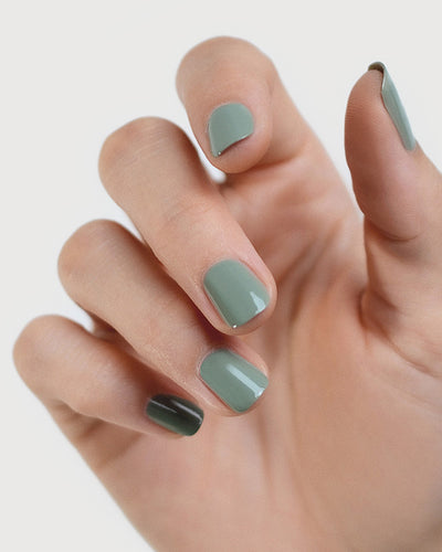 Fair skin hand wearing Soundscape sage green crème nail polish by Sienna Byron Bay close-up