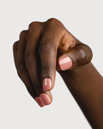 Stony mauve nail polish hand swatch on dark skin tone