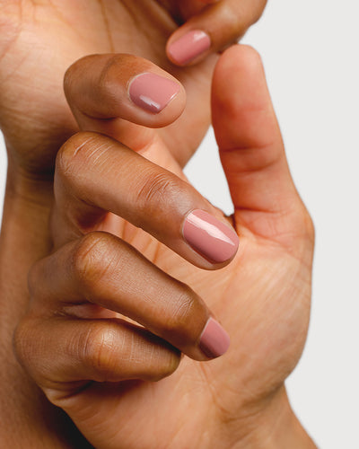 Stony mauve nail polish hands swatch on medium skin tone close-up