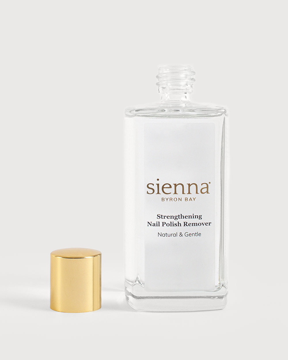 Strengthening nail polish remover bottle on white background with cap off