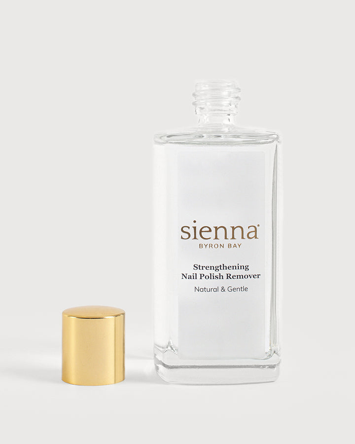 Strengthening nail polish remover bottle on white background with cap off