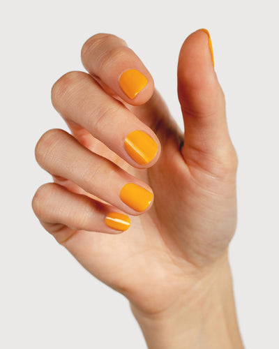 Sunflower yellow nail polish hand swatch on fair skin tone