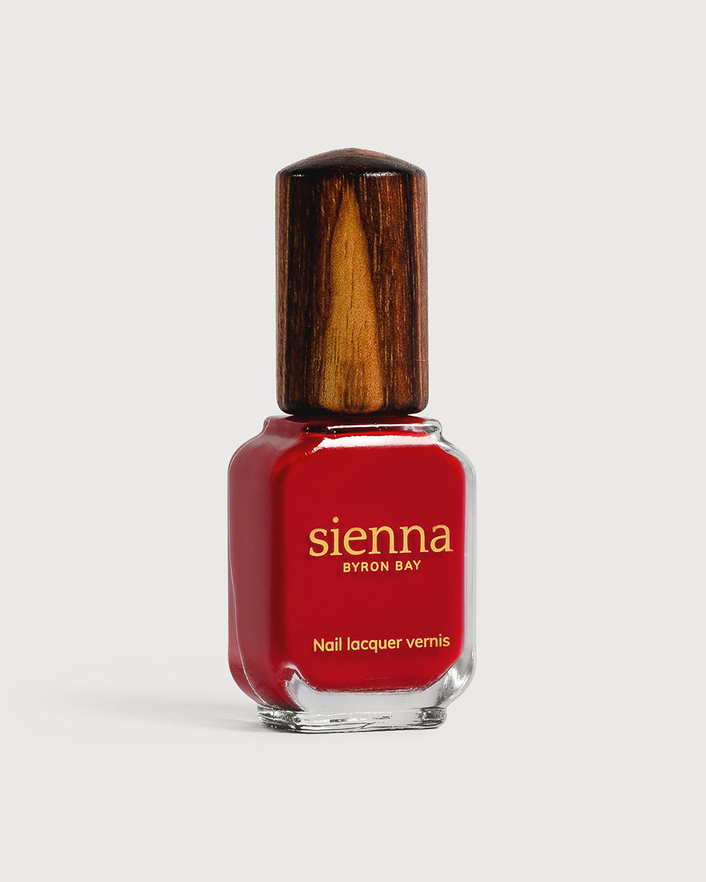 Classic red nail polish glass bottle with timber cap