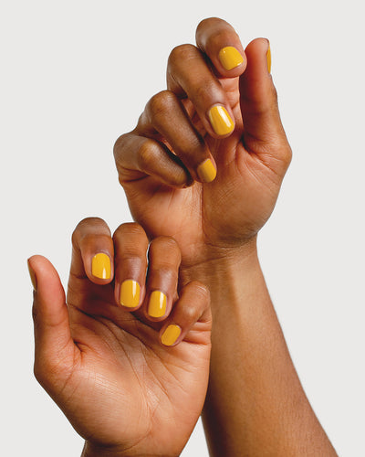 Tuscan sun yellow nail polish hand swatch on both medium skin tone