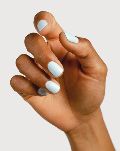 Pastel blue nail polish hand swatch on medium skin tone