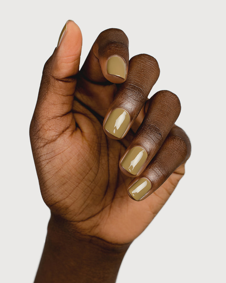 Khaki green nail polish hand swatch on dark skin tone