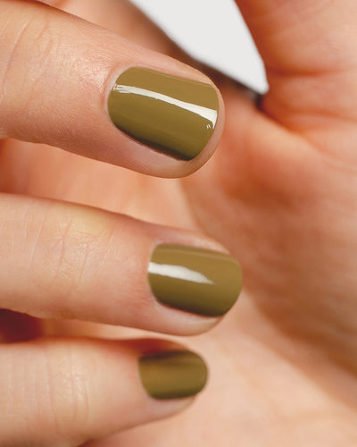 khaki green nail polish hand swatch on fair skin tone close-up